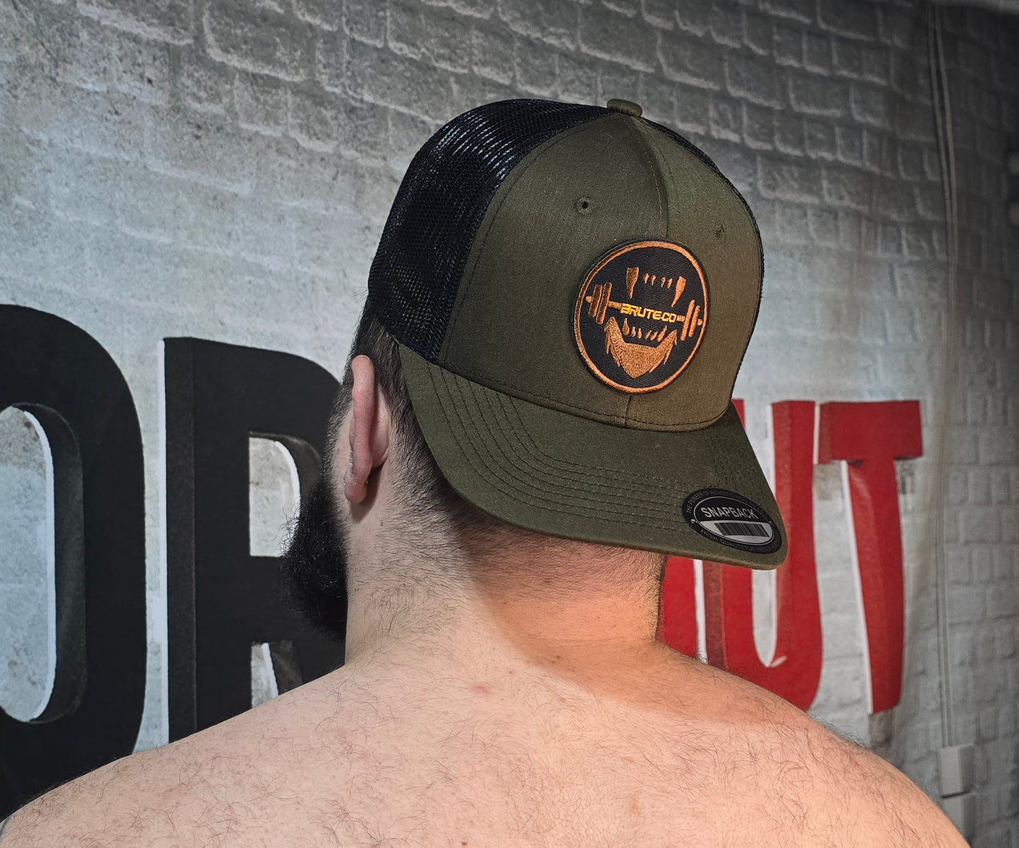 Brute Co Round Brown and Orange Logo on a Hunter Green Snapback